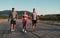 Three runners sprinting outdoors - Sportive people training in a urban area, healthy lifestyle and sport concepts