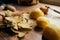 Three russet potatoes peeled and ready for cooking, with leftover peels on the table