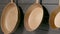 Three rustic copper fryingpans hanging on wooden grey kitchen wall in restaurant or at home. Round empty gold pans with