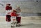 Three rustic snowmen standing on wood surface with a wood background