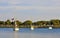 Three sailboats near a dock