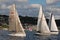 Three sailboats race on Lake Union