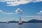 Three sailing boats on water lefkas shore mountains clouds blue