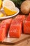 Three salmon pieces on a chopping board