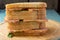 Three sandwiches with smoked pork on wooden plate