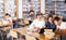 Three schoolchildren are looking for the necessary information on a laptop