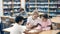 Three schoolchildren, who are engaged in lessons in the school library, make an synopsis of the necessary material from