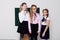 Three schoolgirl girls standing at the school board in class