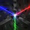 Three scientific lasers emitting RVB light with an explosion of colorful particles on the center