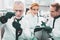 Three scientific researchers in green gloves