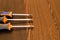 Three screwdrivers are lying on a wooden table