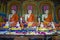 Three sculptures of a sitting Buddha, Buddhist temple