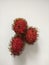 Three seasonal tropical fruits of rambutan fruits at top view. These fruits are a sweet and delicious food.