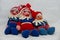 Three self made crocheted colorful gnomes with white background