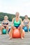 Three senior women with exercise ball