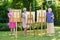 Three senior women painting on canvas in garden or park during sunny day