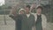 Three serious young men shaking clenched fists and looking at camera. Portrait of group of multiracial guys showing