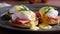 Three servings of eggs benedict on black plate