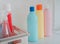 Three set of washing and cleaning liquid bottles on a white shelf for product mock up