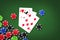 Three sevens, and poker chips, on a green background. copy space. gambling