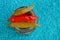 Three sharp small canned peppers on a glass jar on a blue background