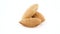 Three shelled almonds. Rotating on the turntable. Isolated on the white background. Close up.