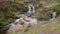 Three Shire Heads. An autumnal waterfall and stone packhorse bridge at Three Shires Head in the Peak District