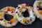 three shortbread cookies with candied fruits on a dark background