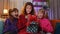 Three siblings children girls opening gift box with excited surprised face, birthday glowing present