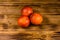 Three sicilian oranges on a wooden table