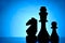 Three silhouetted chess pieces