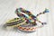 Three simple handmade homemade natural woven bracelets of friendship on white wooden table