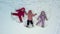 three Sister triplets twins kids making snow angels drone footage
