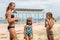 Three sisters on the beach in bathing bikinis