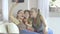 Three sisters in different age at home holding up a smartphone to take a picture