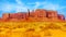 The Three Sisters and Mitchell Mesa, a few of the many massive Red Sandstone Buttes and Mesas in Monument Valley