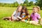 Three sisters read book in the park