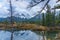 The Three Sisters trio peaks mountain reflect on water surface in autumn. Beautiful scenery at Canmore, Canadian Rockies