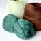 Three skeins for knitting brown, dark green and light green