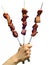 Three skewers of shish kebabs in a hand of the man