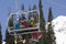 Three Skiers On Chair Lift