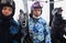 Three skiers in helmets ride on funicular