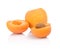 Three sliced apricots on white