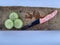 three slices of a cucumber rich in nutrients and antioxidants on a board with a knife on the side
