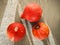 Three small beautiful bright pumpkins lie on a concrete surface. View from above. Hard light.