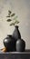 Three Small Black Vessels With Leaves - A Painting By Brian Wallace