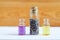 Three small bottles with dry lavender buds, essential oil and natural perfume. Aromatherapy and spa ingredients.