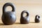 Three small calibration weights on wooden background. Small DOF