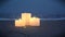 Three small candles on sandy beach near sea ocean waves burning