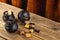 Three small cauldrons with different candies stand on a wooden table, with a velvet curtain in the background.